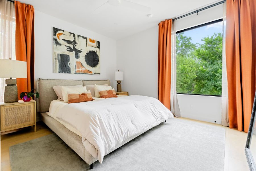 Bedroom with ceiling fan and wood finished floors