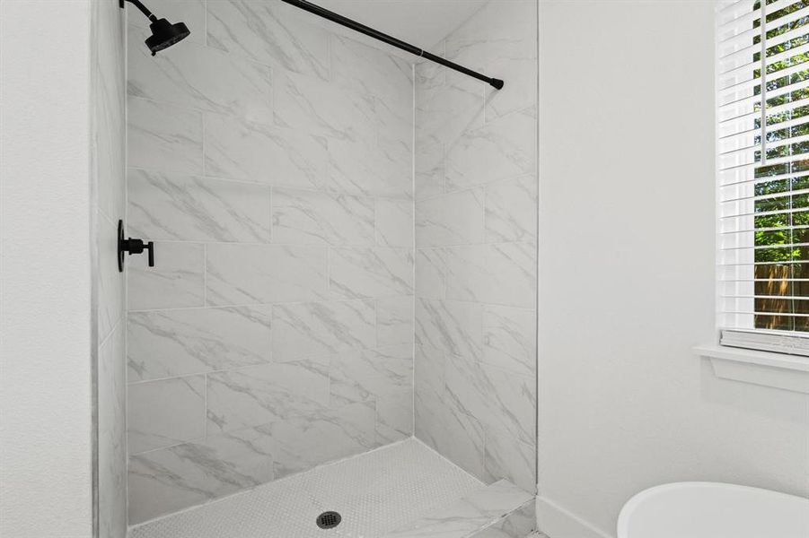 Full bathroom with a shower stall