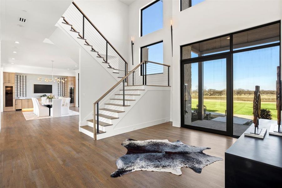 Custom 10' pivot-style iron door welcomes you into this foyer.
