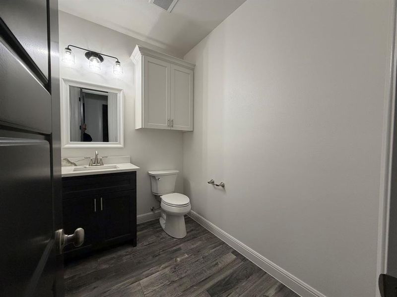 Modern vanity with a light-toned countertop, brushed nickel faucet, and framed mirror