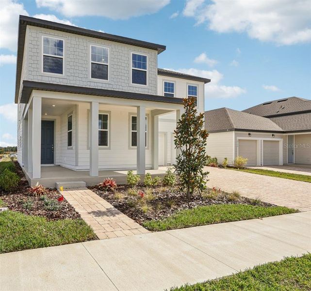 Front exterior of a new home in Trailside, Mount Dora, FL, highlighting curb appeal (Image 1).