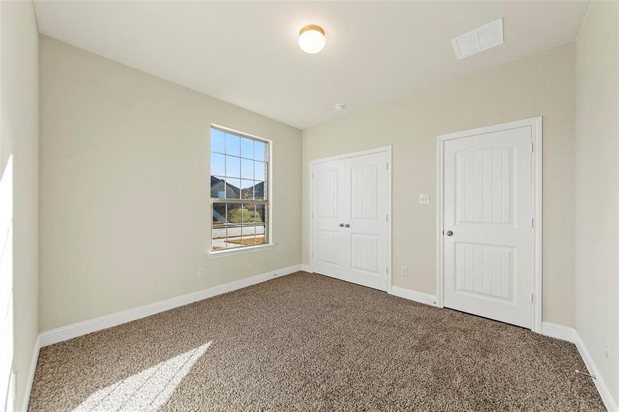 Unfurnished bedroom with carpet flooring