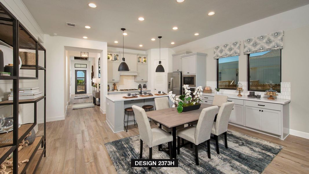 Dining room with recessed lighting and light wood-style floors Dining room with recessed lighting and light wood-style floors
