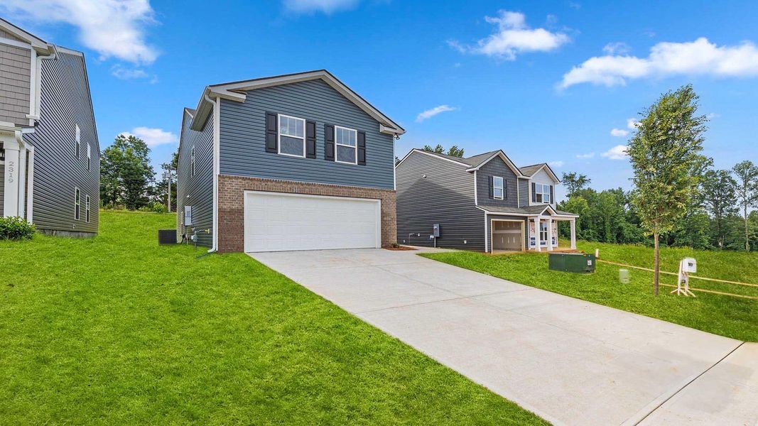 Front exterior of a new home in Harrier Point, Woodruff, SC, highlighting curb appeal (Image 21). Front exterior of a new home in Harrier Point, Woodruff, SC, highlighting curb appeal (Image 21).