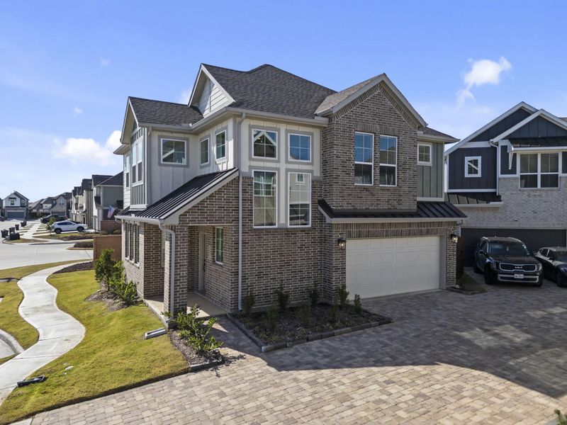 Front exterior of a new home in Meridiana, Manvel, TX, highlighting curb appeal (Image 22).