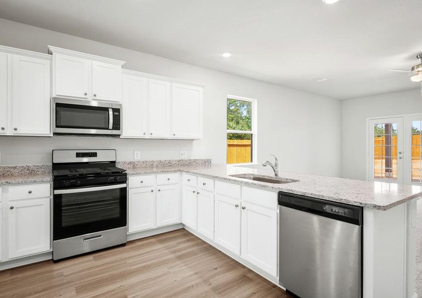 The chef ready kitchen with stainless steel appliances.