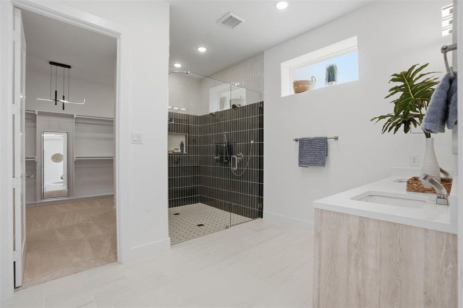Frameless glass shower · Calacatta white quartz countertops · Delta Trinsic Series fixtures * spa-inspired finishes in the first-floor primary bath Frameless glass shower · Calacatta white quartz countertops · Delta Trinsic Series fixtures * spa-inspired finishes in the first-floor primary bath