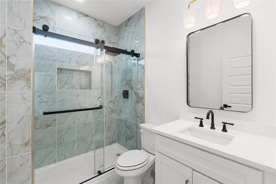 Bathroom with vanity and a marble finish shower Bathroom with vanity and a marble finish shower