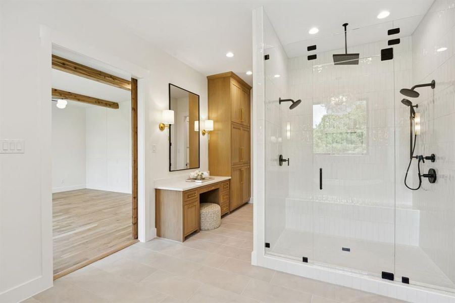 Oversized shower and a seated vanity. Not pictured is a separate laundry room for the primary suite. Oversized shower and a seated vanity. Not pictured is a separate laundry room for the primary suite.