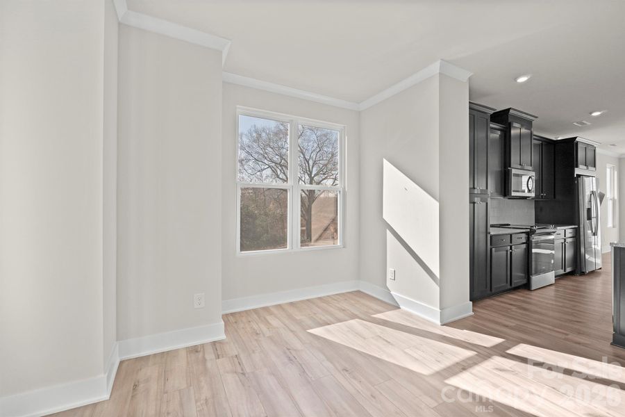 Adjacent to the kitchen, the light-filled dining area offers the perfect space for everyday meals or entertaining, enhanced by oversized windows and modern finishes. Adjacent to the kitchen, the light-filled dining area offers the perfect space for everyday meals or entertaining, enhanced by oversized windows and modern finishes.