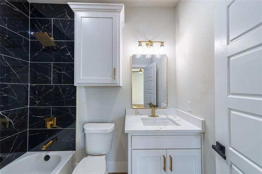 Full bathroom featuring vanity and shower / washtub combination Full bathroom featuring vanity and shower / washtub combination