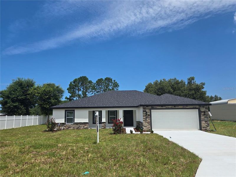 Front exterior of a new home in , Spring Hill, FL, highlighting curb appeal (Image 25).