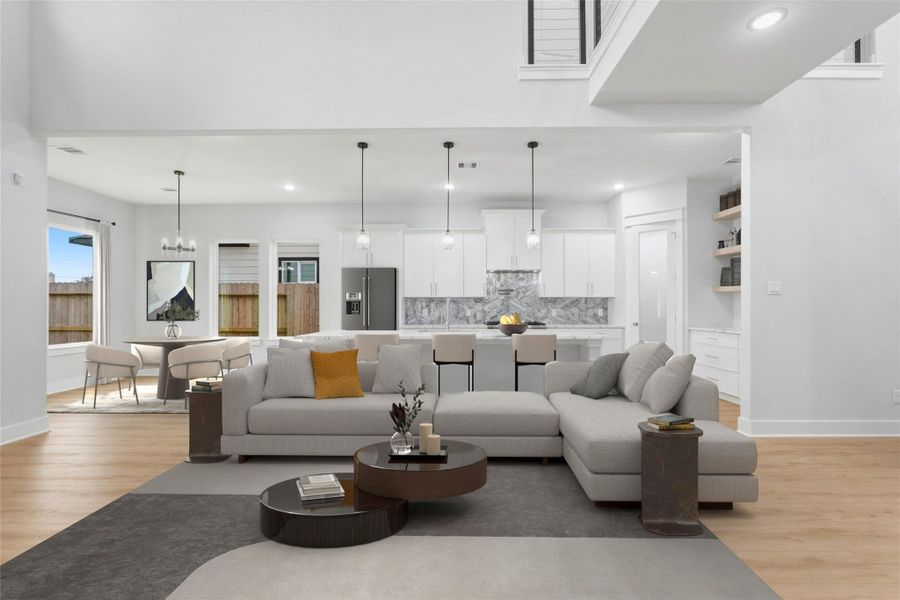 Spacious open-concept living area with high 20-foot ceilings, seamlessly connecting the living room, dinning space, and modern kitchen. Featuring abundant natural light, sleek finishes, and a 10-foot island with seating area. (virtual staging)