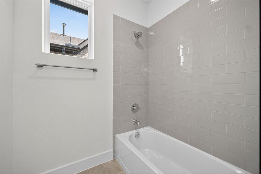 Bathroom featuring shower / washtub combination and tile patterned floors