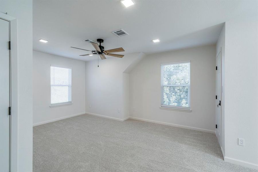 Bonus room featuring light carpet and ceiling fan