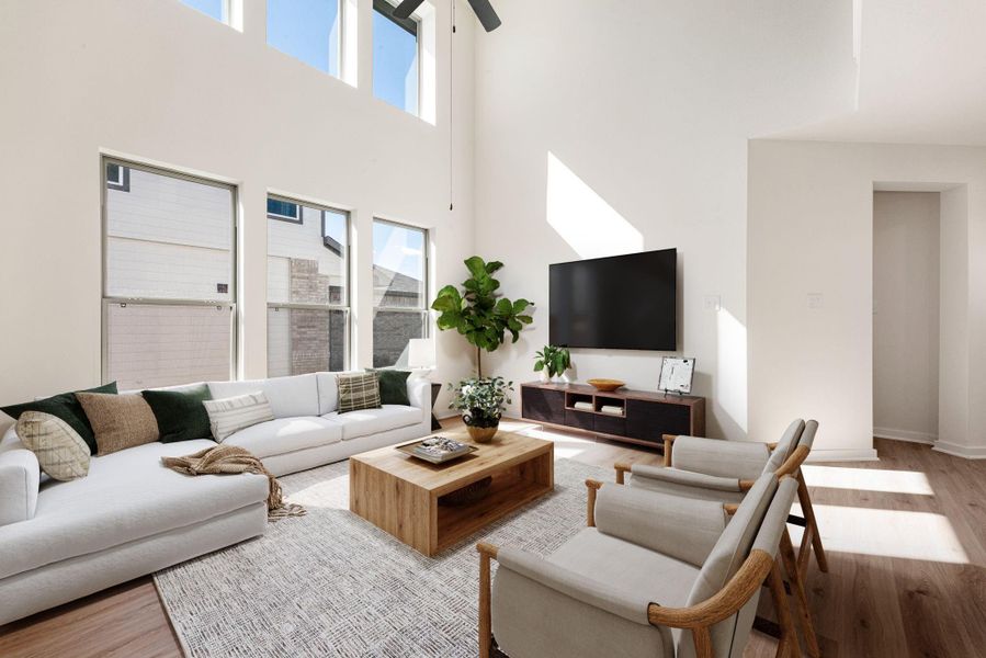 This bright and airy living room showcases soaring ceilings and an impressive wall of windows that fill the space with natural light. The open design highlights clean lines and a modern feel, complemented by warm wood flooring and soft neutral tones. It’s a stunning centerpiece for the home—perfect for relaxing or entertaining in style. This bright and airy living room showcases soaring ceilings and an impressive wall of windows that fill the space with natural light. The open design highlights clean lines and a modern feel, complemented by warm wood flooring and soft neutral tones. It’s a stunning centerpiece for the home—perfect for relaxing or entertaining in style.