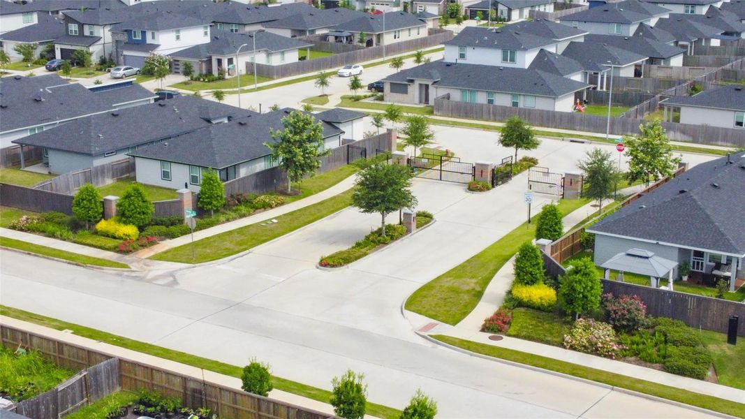 This elevated perspective highlights the manicured landscaping, wide streets, and thoughtful layout of this gated neighborhood. Residents enjoy peace of mind with controlled access and the beauty of mature greenery, all within a cohesive, beautifully maintained environment. This elevated perspective highlights the manicured landscaping, wide streets, and thoughtful layout of this gated neighborhood. Residents enjoy peace of mind with controlled access and the beauty of mature greenery, all within a cohesive, beautifully maintained environment.