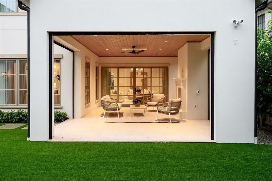 Covered climate-controlled patio with retractable screens and gas fireplace