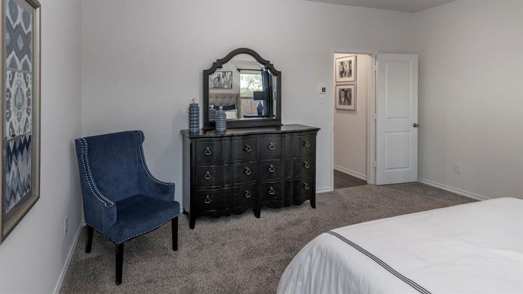 Carpeted bedroom featuring baseboards