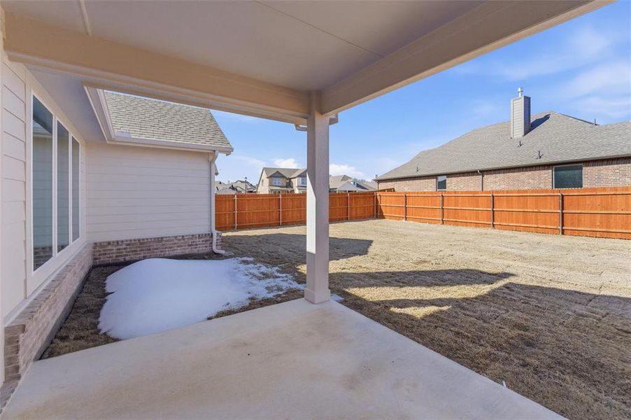 Fenced backyard with a patio area