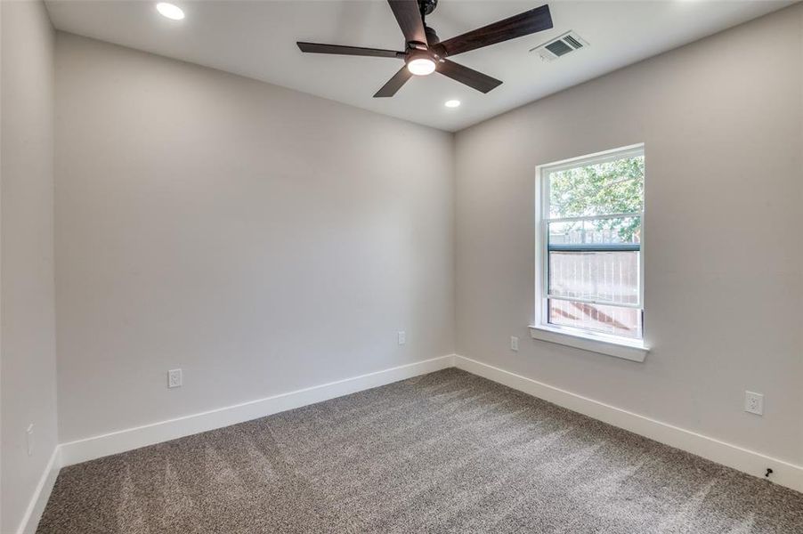 bedroom with ceiling fan and carpet floors