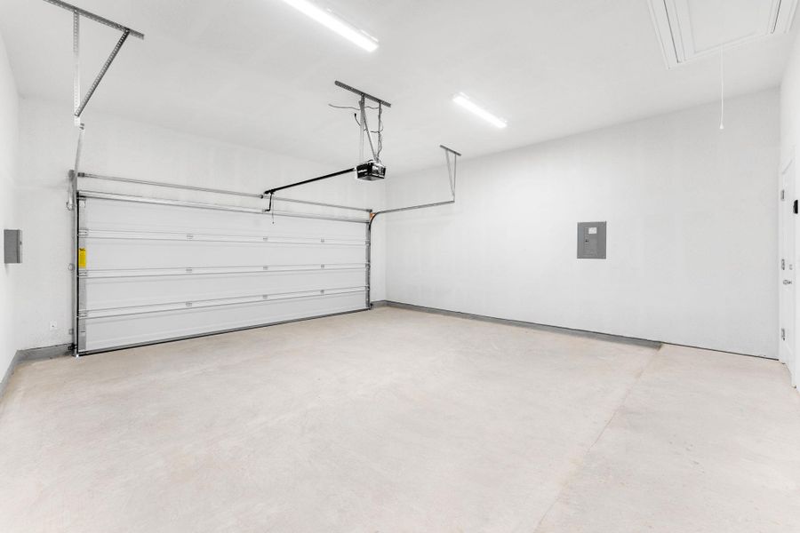 A spacious, freshly painted garage offers ample room for vehicles and storage. A spacious, freshly painted garage offers ample room for vehicles and storage.