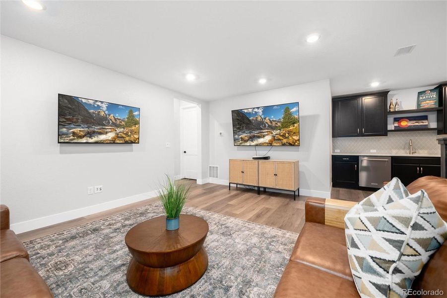 Imagine watching games and movies in your finished basement complete with family room and bar!