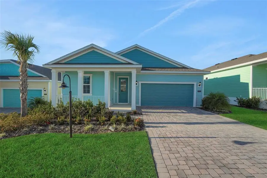 Front exterior of a new home in Green Key Village, Lady Lake, FL, highlighting curb appeal (Image 1). Front exterior of a new home in Green Key Village, Lady Lake, FL, highlighting curb appeal (Image 1).