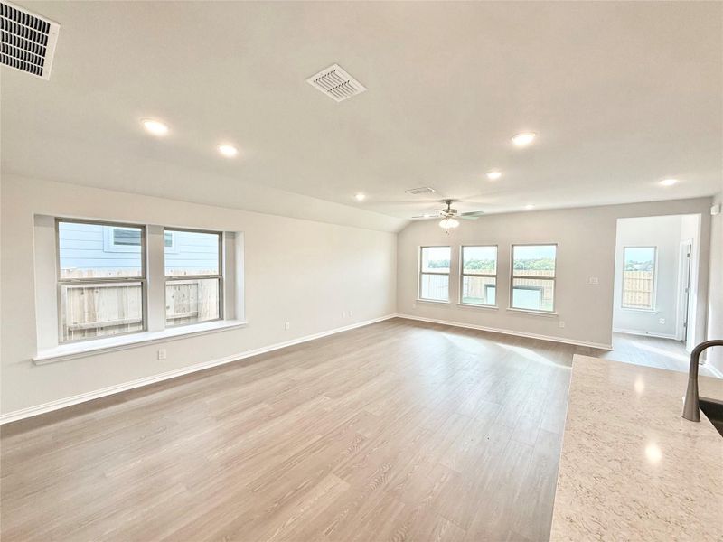 Unfurnished living room with light wood finished floors, recessed lighting, and ceiling fan Unfurnished living room with light wood finished floors, recessed lighting, and ceiling fan