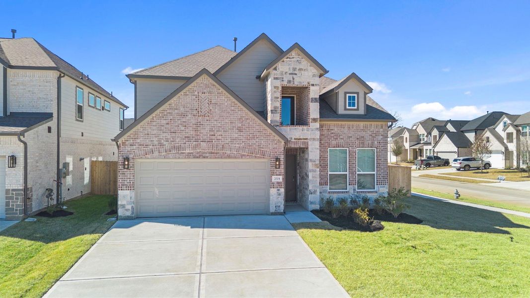 Front exterior of a new home in Barton Creek Ranch, Conroe, TX, highlighting curb appeal (Image 2). Front exterior of a new home in Barton Creek Ranch, Conroe, TX, highlighting curb appeal (Image 2).