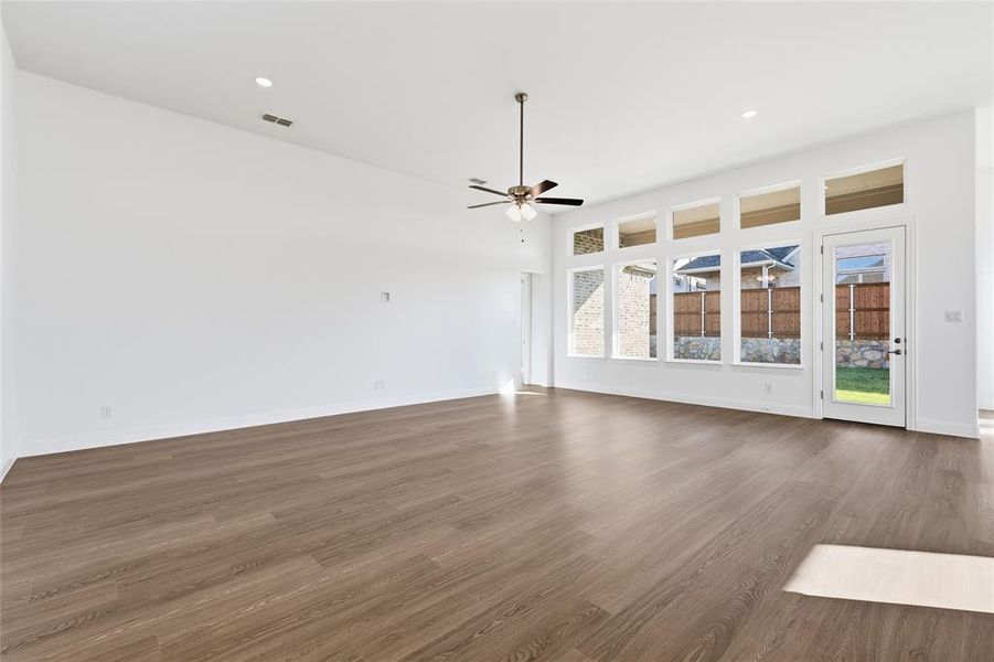 Spare room featuring wood finished floors and recessed lighting Spare room featuring wood finished floors and recessed lighting