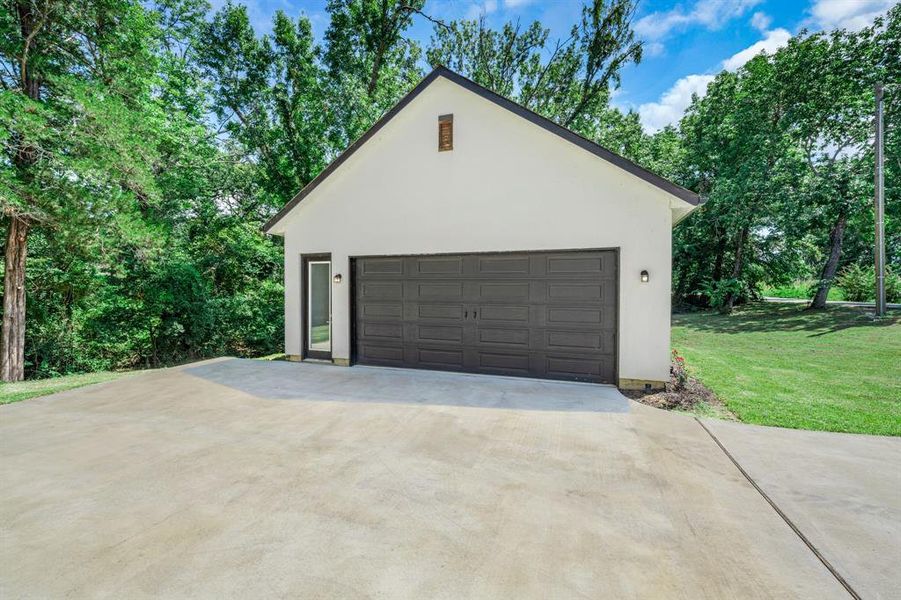 Detached garage with view of scattered trees Detached garage with view of scattered trees