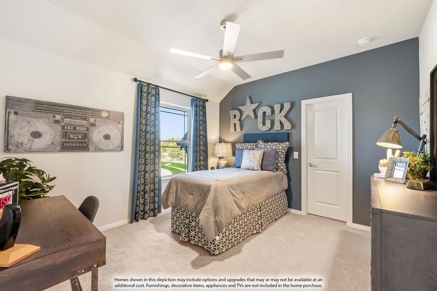 Bedroom with blue accent wall, vaulted ceiling, ceiling fan, and carpet flooring