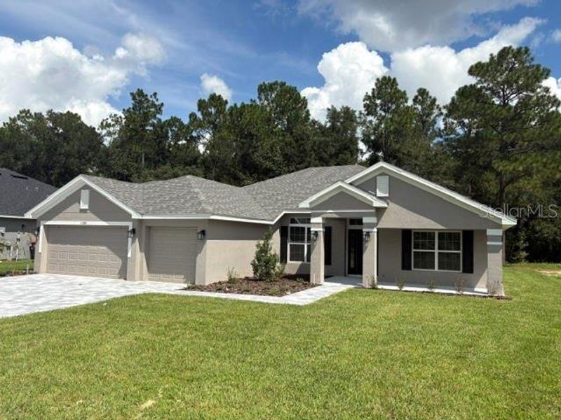 Front exterior of a new home in Juliette Falls, Dunnellon, FL, highlighting curb appeal (Image 10).
