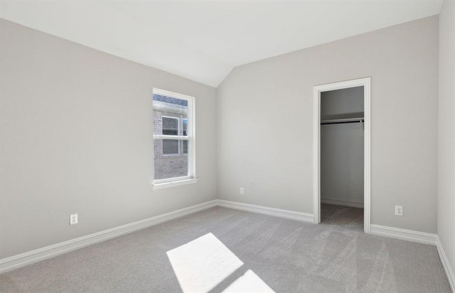 Spacious secondary bedroom with ample closet space *real home pictured