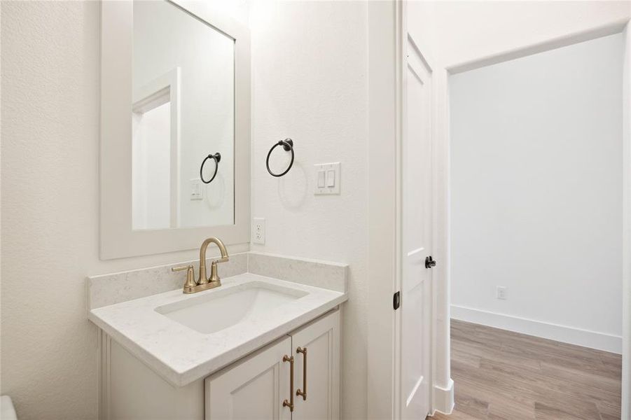 Bathroom featuring hardwood / wood-style flooring and vanity