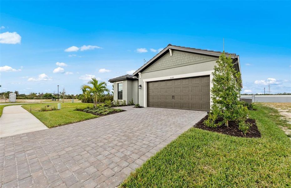 Front exterior of a new home in , North Port, FL, highlighting curb appeal (Image 1). Front exterior of a new home in , North Port, FL, highlighting curb appeal (Image 1).
