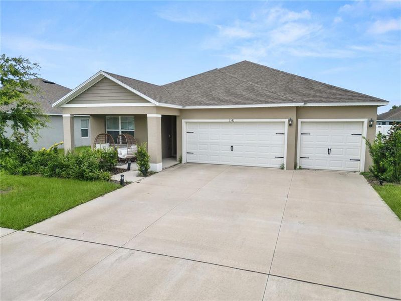 Front exterior of a new home in Wind Meadows South, Bartow, FL, highlighting curb appeal (Image 27). Front exterior of a new home in Wind Meadows South, Bartow, FL, highlighting curb appeal (Image 27).