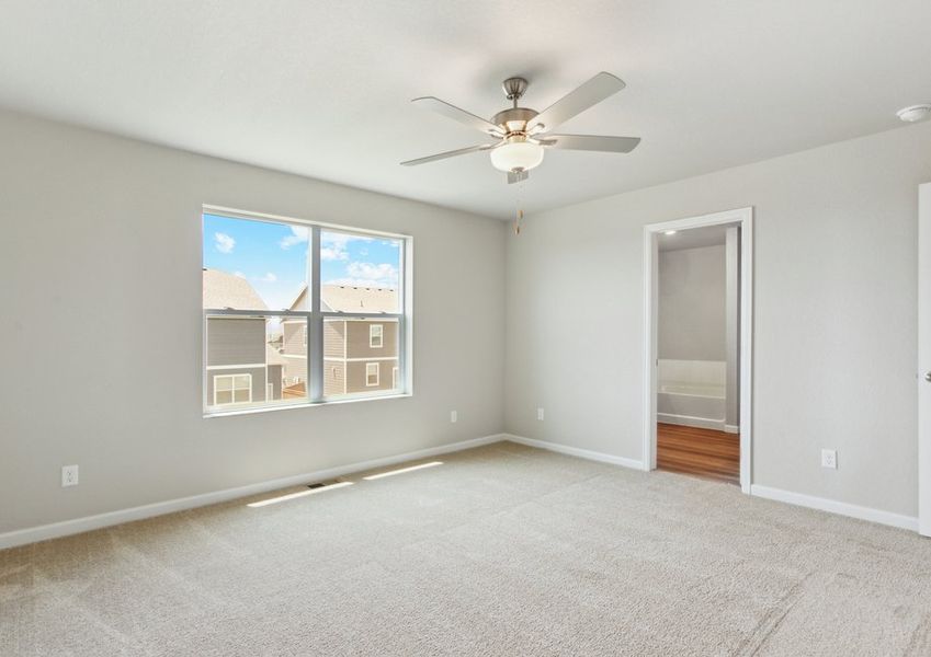 The master bedroom is spacious with a large window.