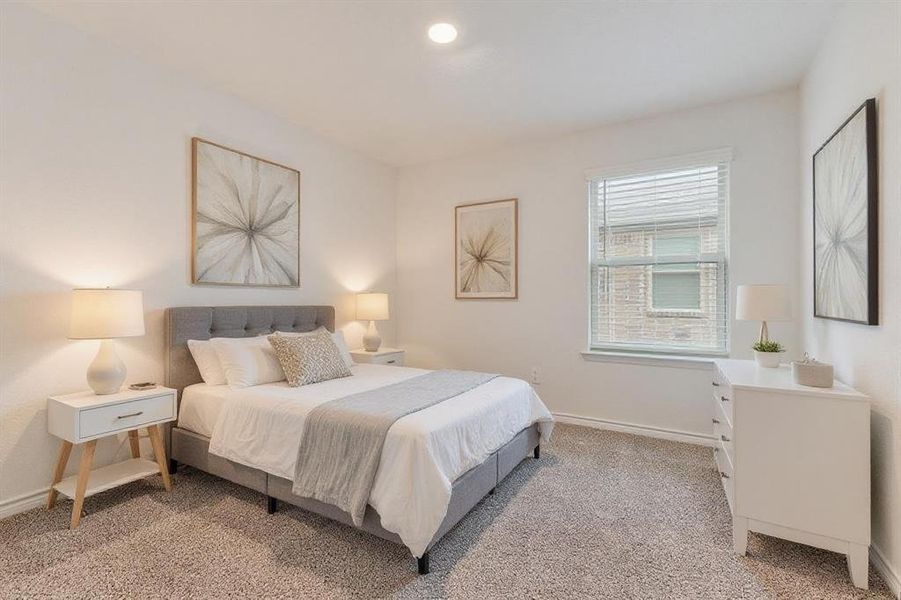 Bedroom with light colored carpet