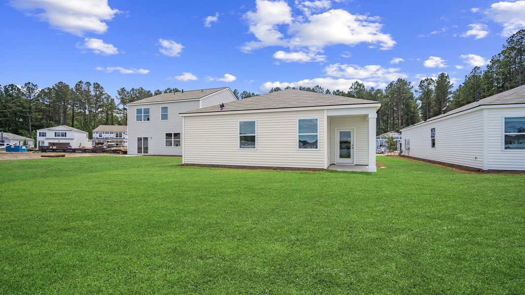 Front exterior of a new home in The Retreat at East Argent, Ridgeland, SC, highlighting curb appeal (Image 24). Front exterior of a new home in The Retreat at East Argent, Ridgeland, SC, highlighting curb appeal (Image 24).
