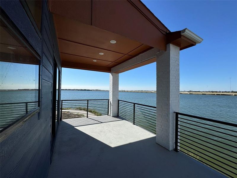 View of patio / terrace with a balcony and a water view