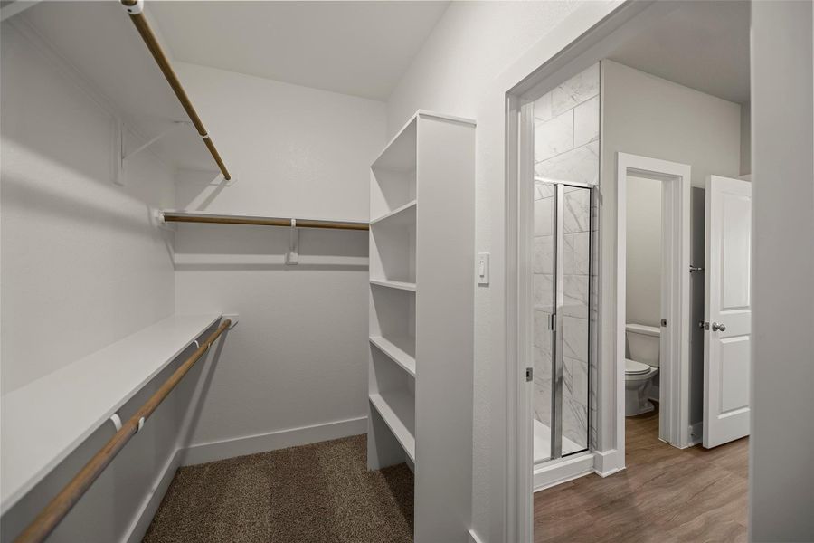 Crisp finishes, elegant hardware, and a roomy walk-in closet complete the luxurious feel.