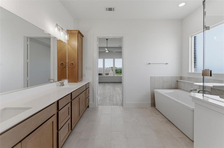Double vanity with integrated sinks and a light-toned countertop