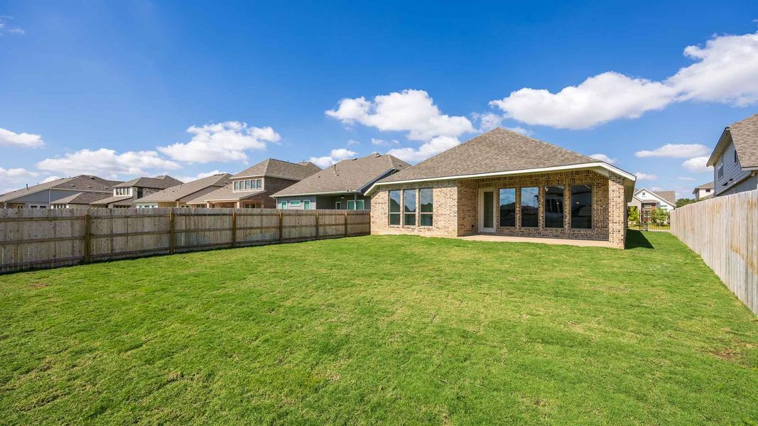 Back of house featuring a residential view, a patio area, brick siding, roof with shingles, and a fenced backyard Back of house featuring a residential view, a patio area, brick siding, roof with shingles, and a fenced backyard