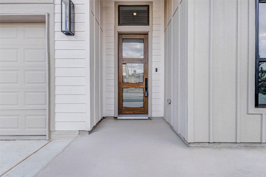 Welcome to 608 E. 26th.  Striking modern entry with clean lines, neutral tones, and a custom wood-and-glass front door creating a refined first impression.!