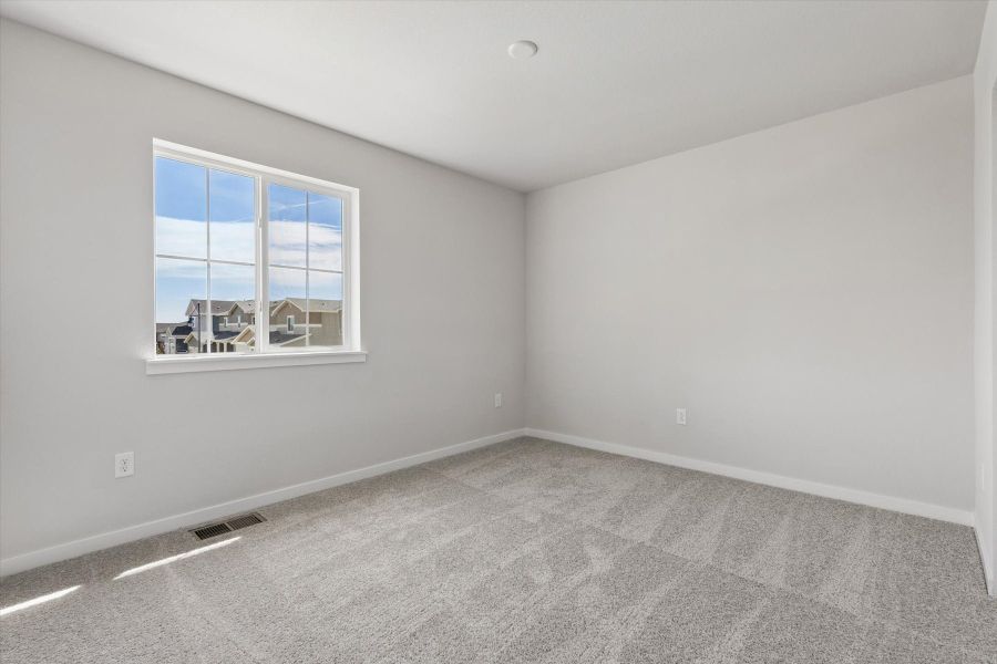 A room with a window and a carpet. A room with a window and a carpet.