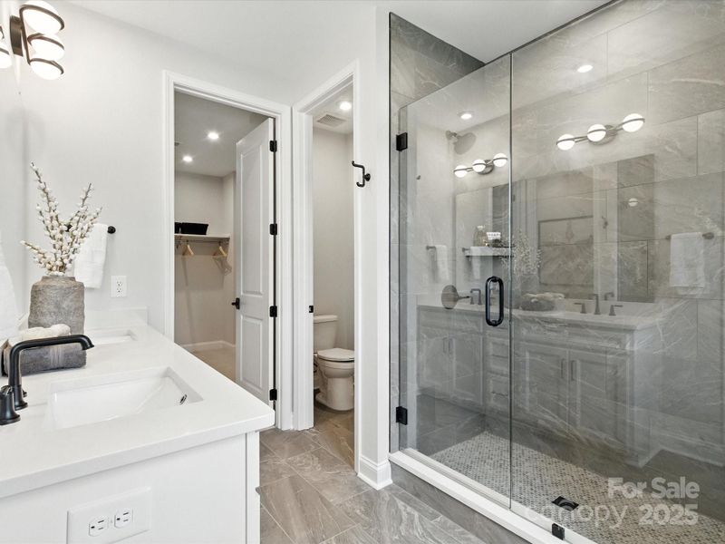 Walk-in shower with modern oversized tile. *Model Photos | Actual finishes, orientation, and structural selections may vary.