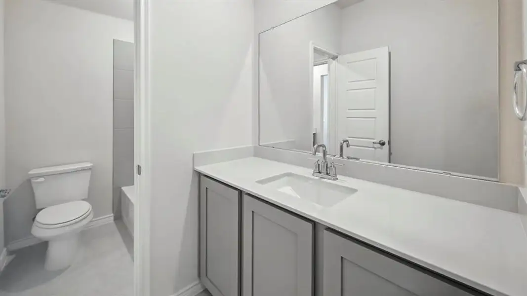 Bathroom with vanity,  shower combination, and light tile patterned flooring