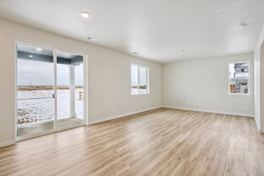 A room with a wood floor and a glass door.